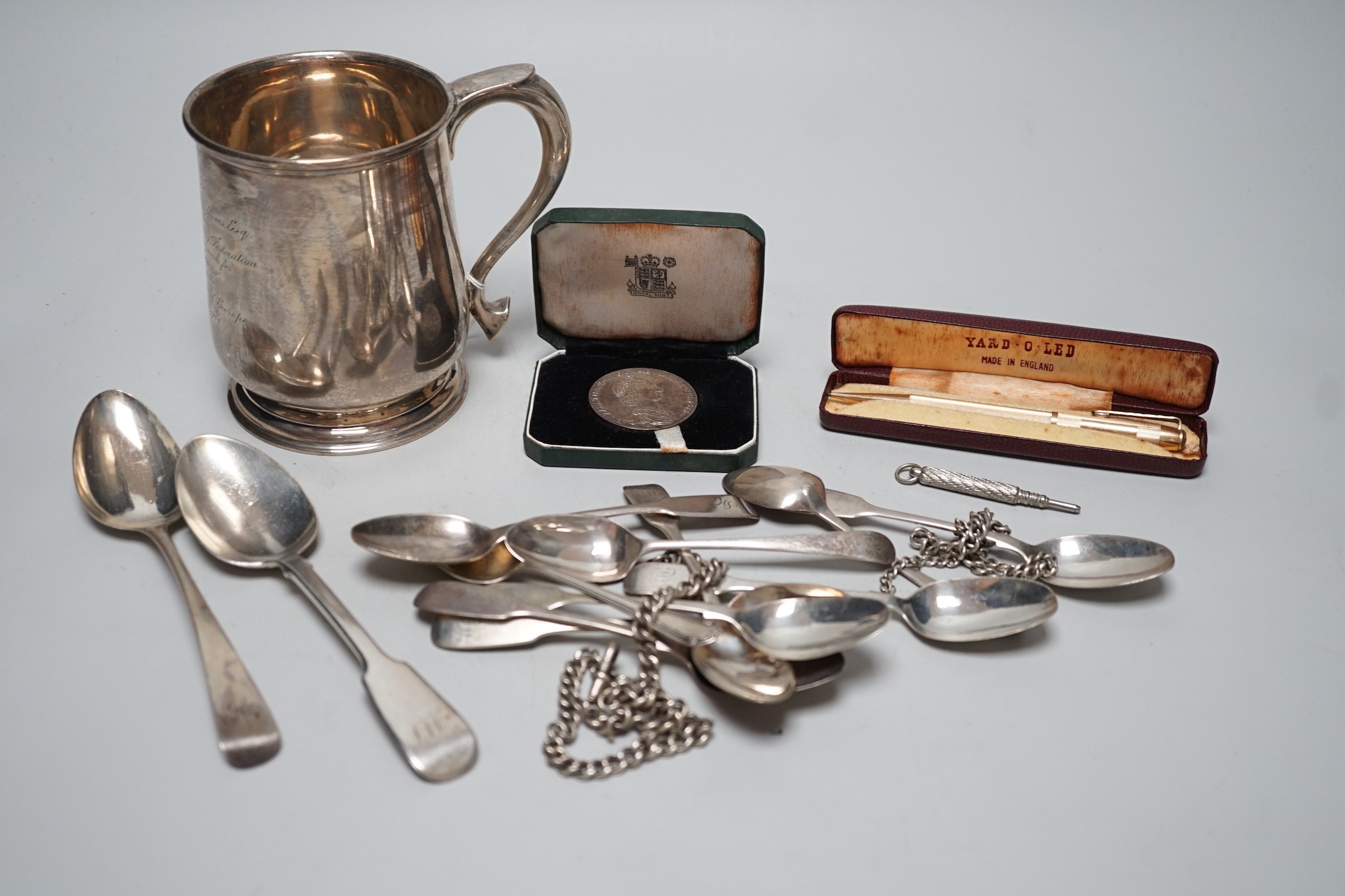 A George VI silver mug, with engraved inscription, James Dixon and Sons, Sheffield, 1943, 11.3cm, together with twelve items of silver flatware including set of six William IV silver fiddle pattern teaspoons, a silver al